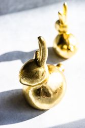 Easter holiday card concept with golden rabbit statues