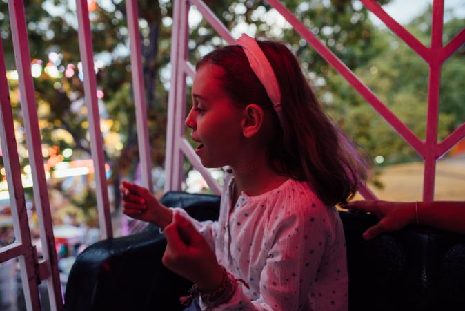 Cheerful girl riding Ferris wheel