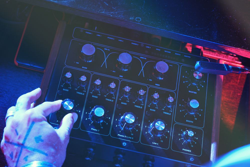 Unrecognizable man playing on DJ mixer