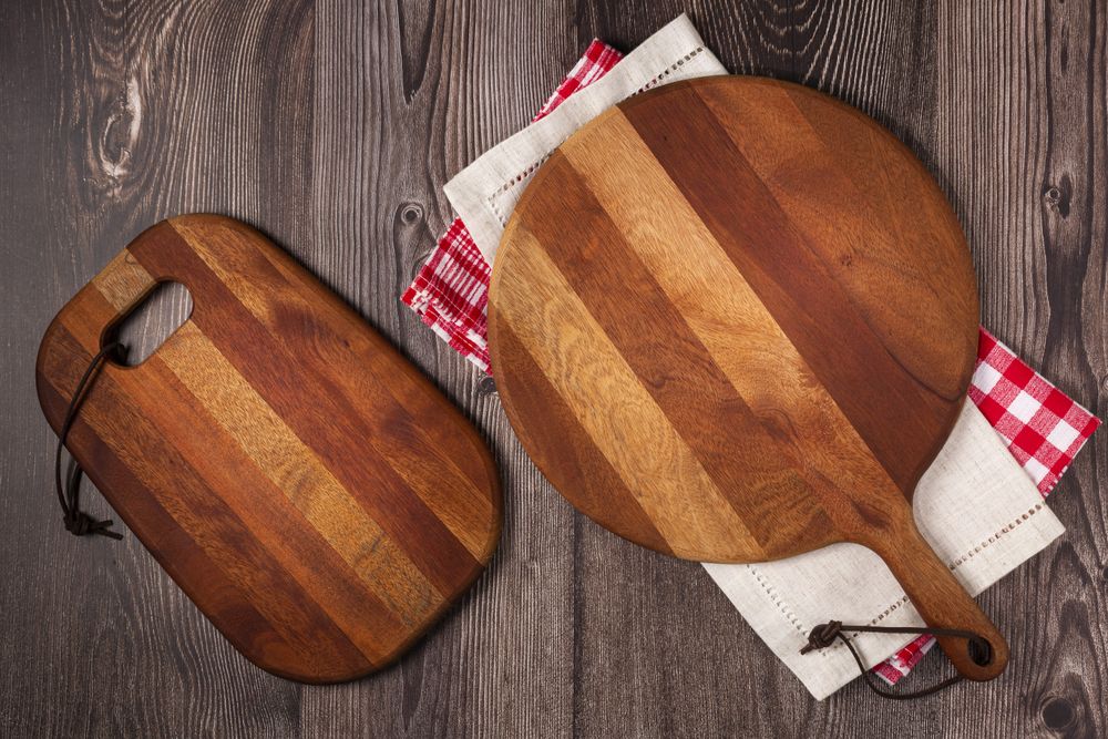 Empty pizza board on rustic wooden table. Top view image.