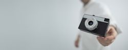 Retro camera floating in hand