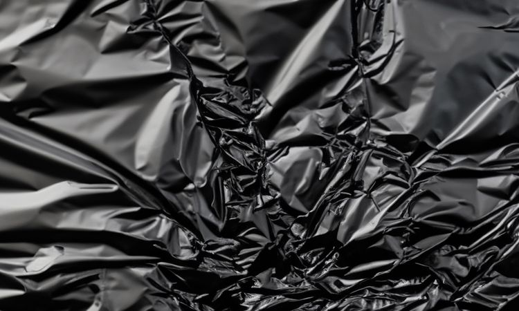 dark crumpled and creased plastic poster texture background
