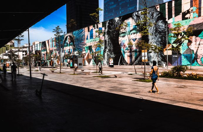 People walking near building and graffiti wall