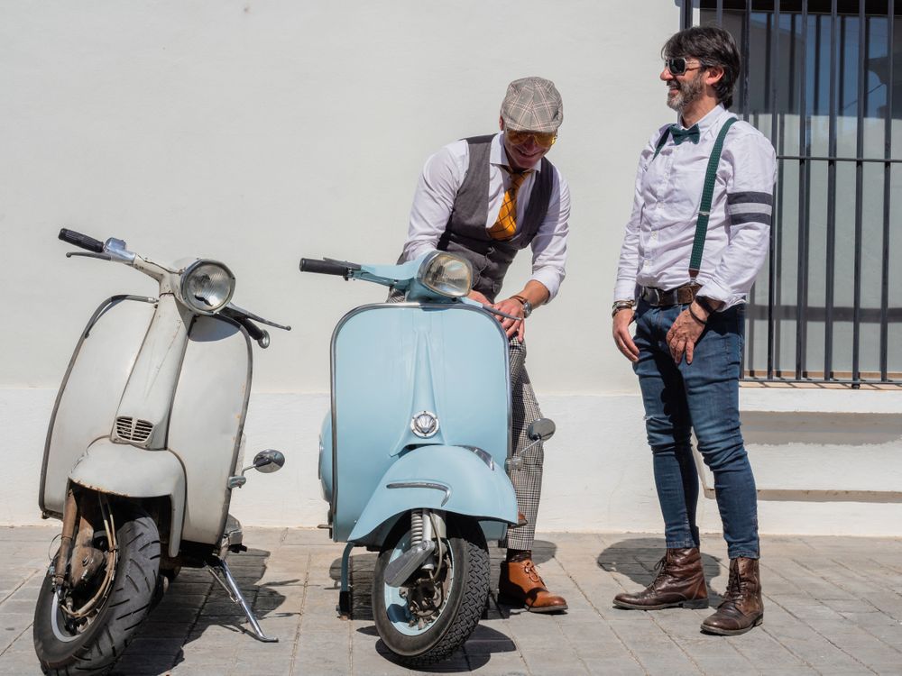 Trendy  men sitting on vintage scooters