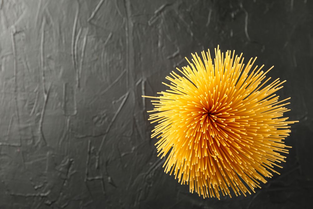 Pasta on dark background, space for text and top view