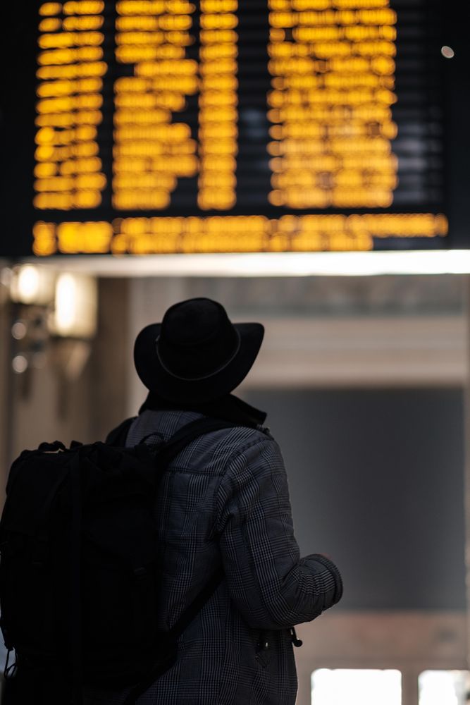 Person with backpack standing inside airport