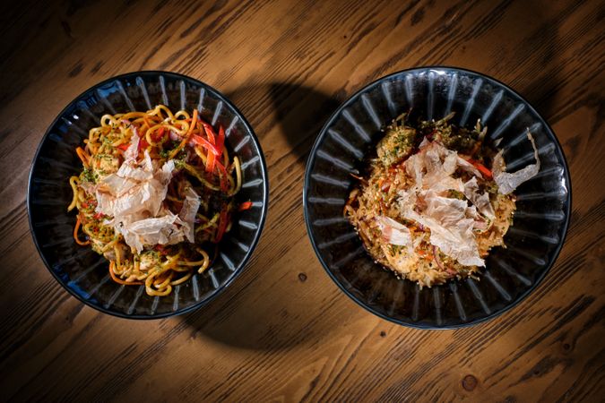 Delicious dishes in bowls served on wooden table