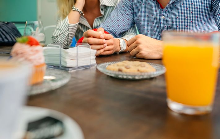 Couple holding hands in a cafe