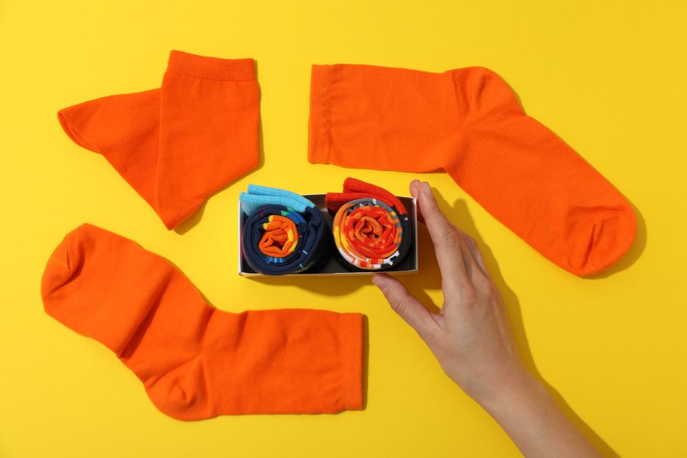 Multicolored high socks on a yellow background.