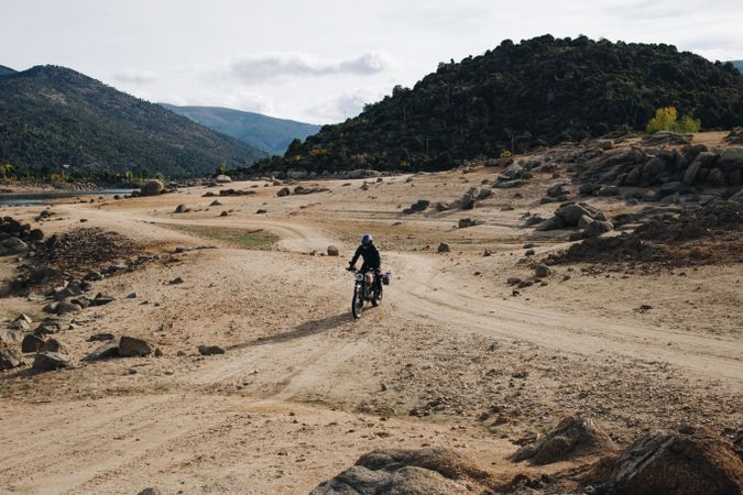 Person riding on motorcycle on gravel travel