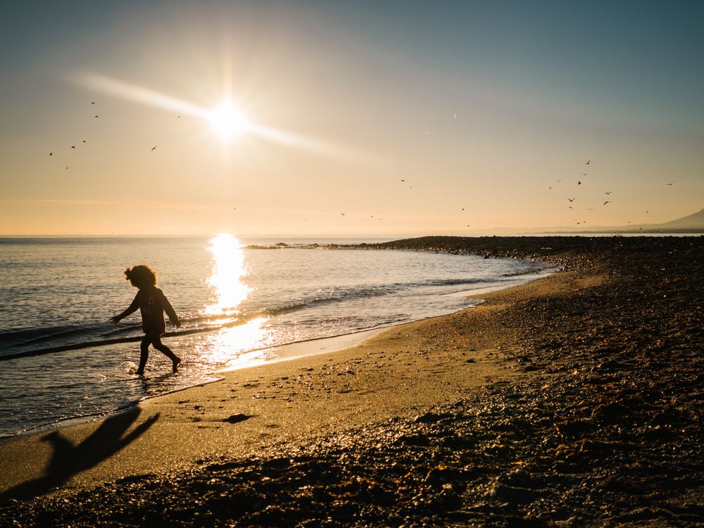 small girl walking by the beach