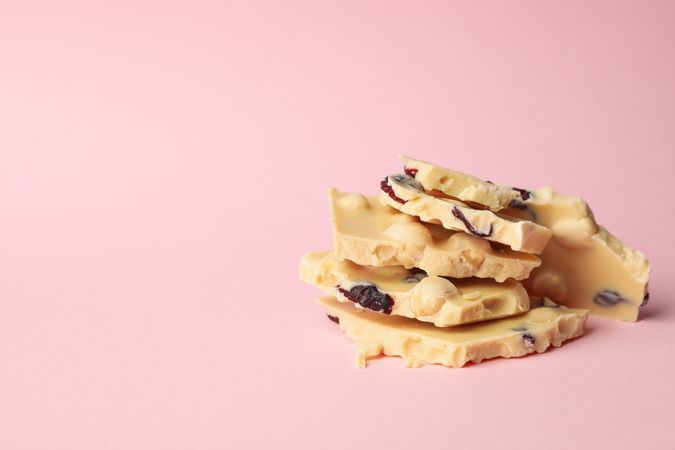 chocolate pieces on pink background. Sweet food