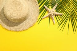 Summer vacation composition on yellow background. Space for text, top view
