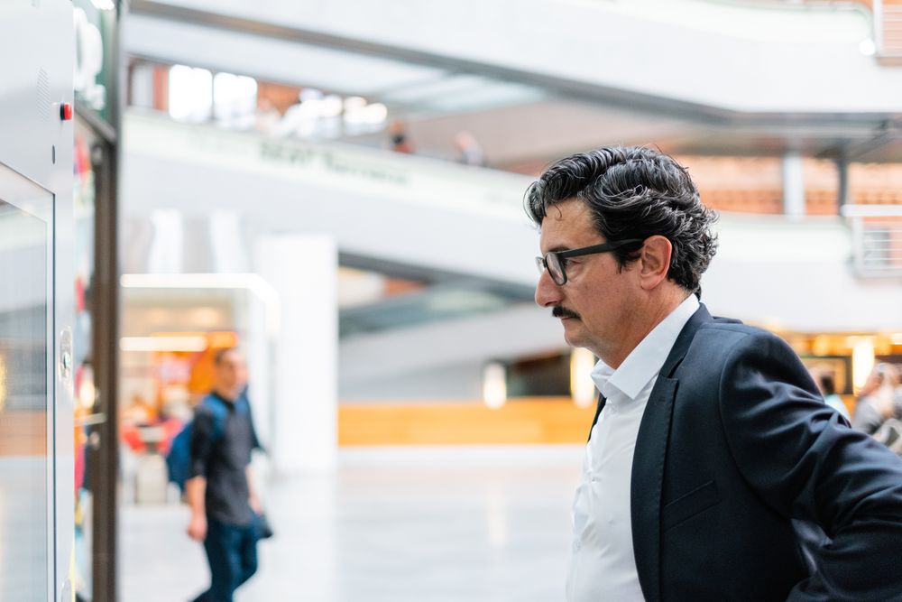 Puzzled older businessman in stylish formal wear at shopping plaza