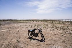 Motorcycle in spacious desert terrain