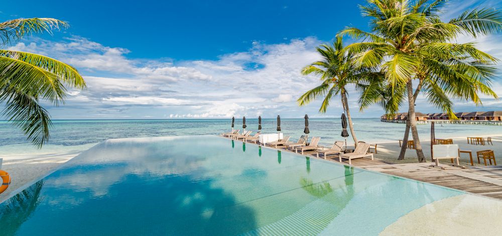 A pool in a resort overlooking the Indian Ocean, wide