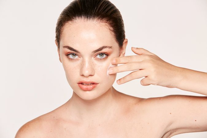 Amiable female taking care of face