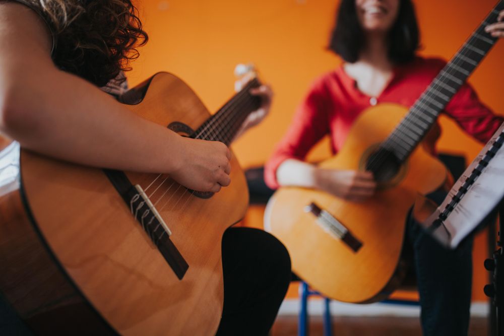 Two guitar players enjoying playing duet together