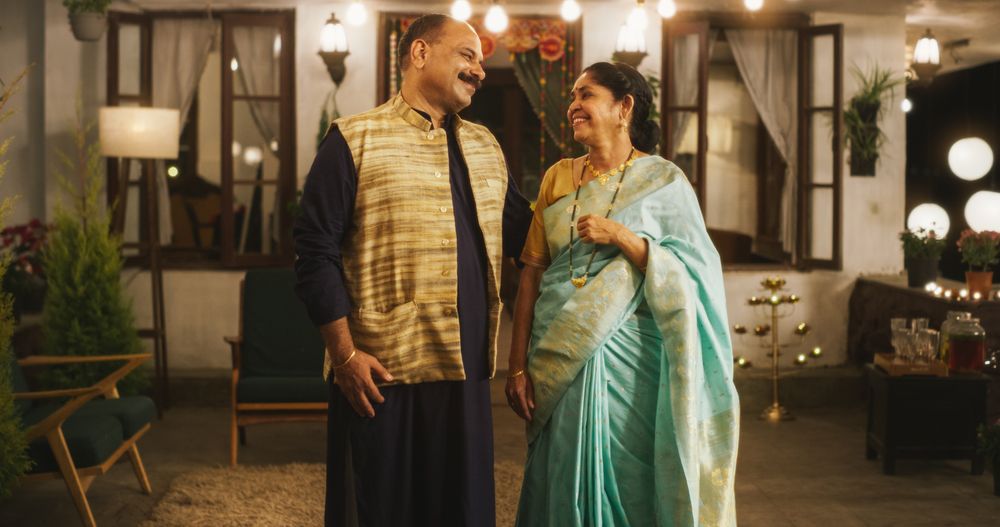 Portrait of Happy Indian  Couple in Traditional Clothes Posing Together at Their Authentic Mumbai Home.