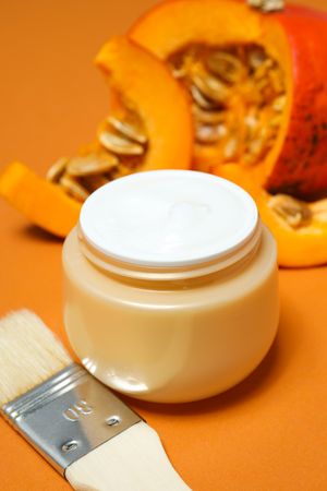 Skin care and face care concept - pumpkin cosmetic