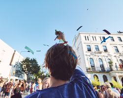 London, England, United Kingdom - August 25th, 2019: Confetti falls through sky onto man’s head