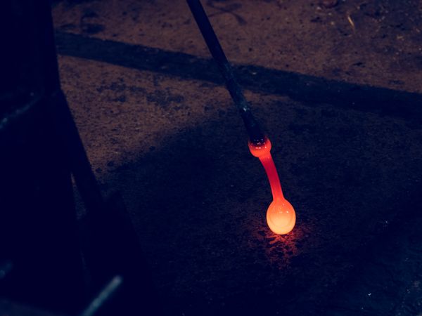 Red hot glass with metal pipe