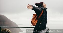 Young woman in winter clothes enjoying holiday on the mountain top 423a7b