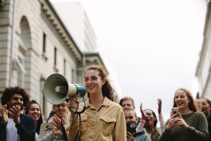 Young woman with group of people in a rally