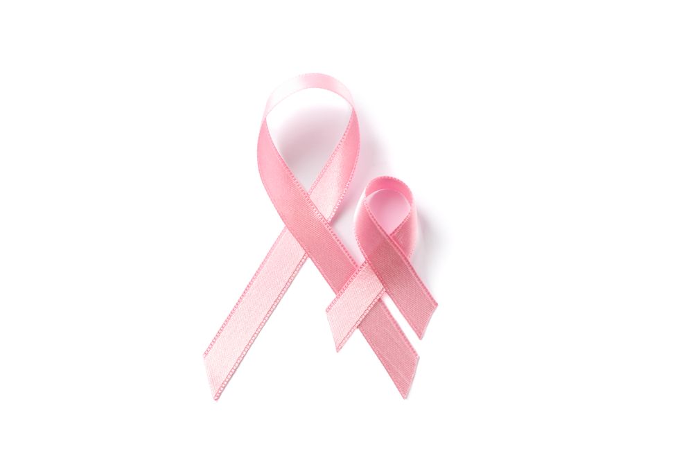 Pink awareness ribbons isolated on blank background, top view