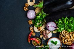 Ingredients for cooking eggplant with walnut dish on rustic background with copy space 48Ba67
