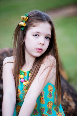 Portrait of young girl wearing yellow and green top