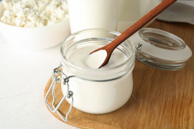 Fresh dairy products on plain wooden table, close up