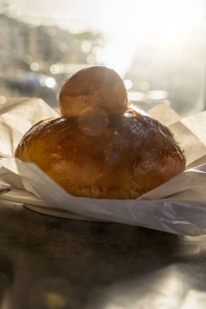 Sicilian brioche with tuppo in golden morning light on cafe table
