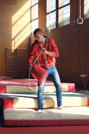 Young sports gymnast arriving at the gym to train exercises, tak