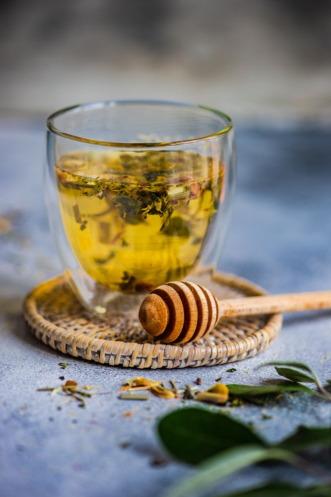 Side view of floral tea in glass