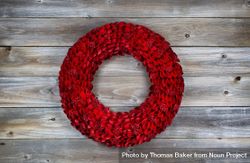 Holiday wooden red wreath on rustic wood 4AreNb