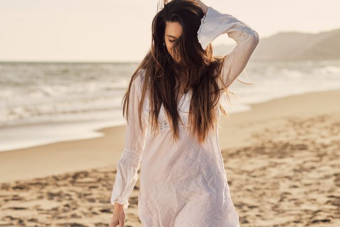Young woman at the beach at sunset