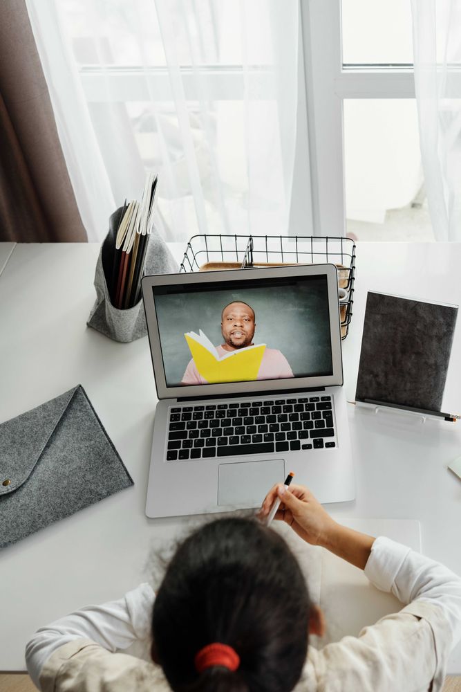 Top view of girl attending an online class using computer