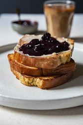 Toasted brioche butter and jam on light close up