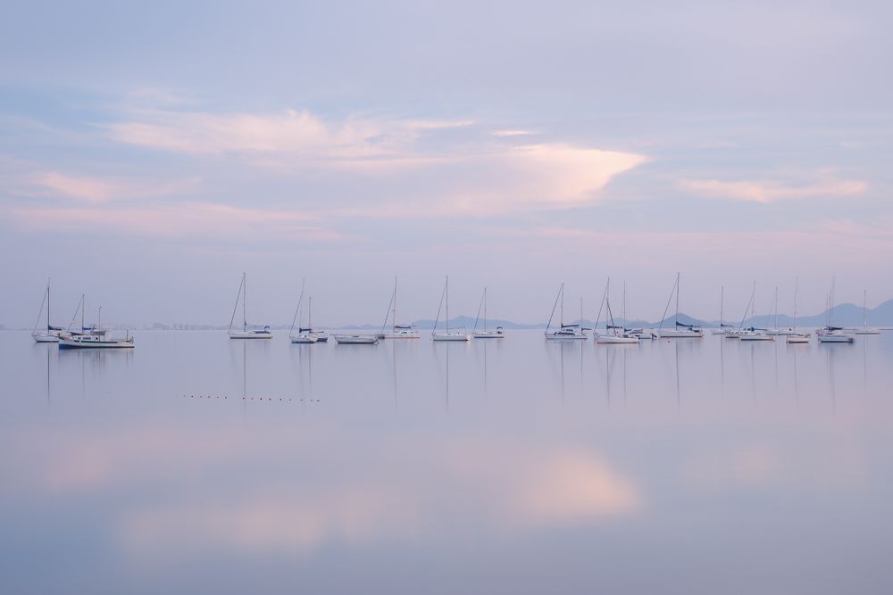 Boats on calm sea water in evening