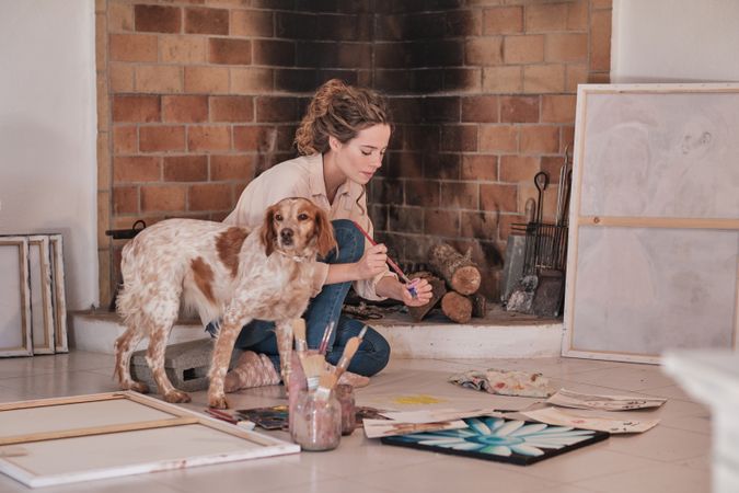 Young woman with dog drawing