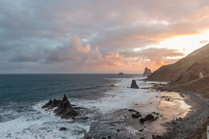 Lonely cliff in sea on cloudy day