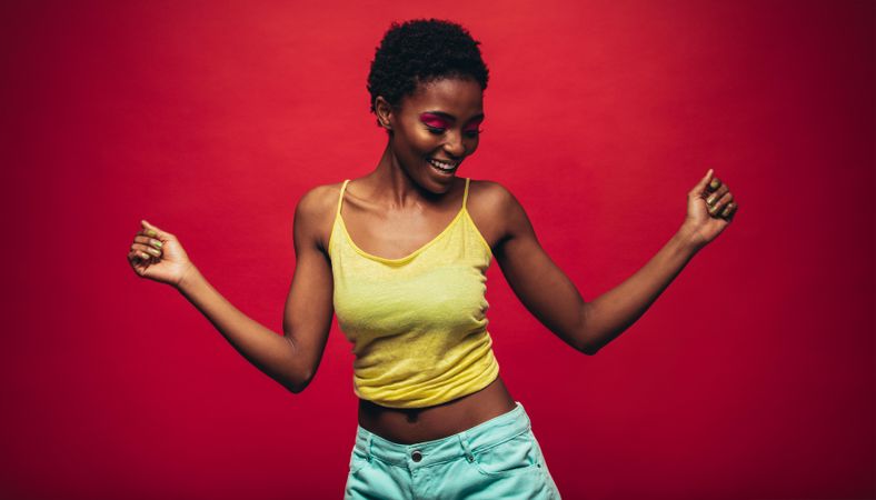Woman dancing over red background