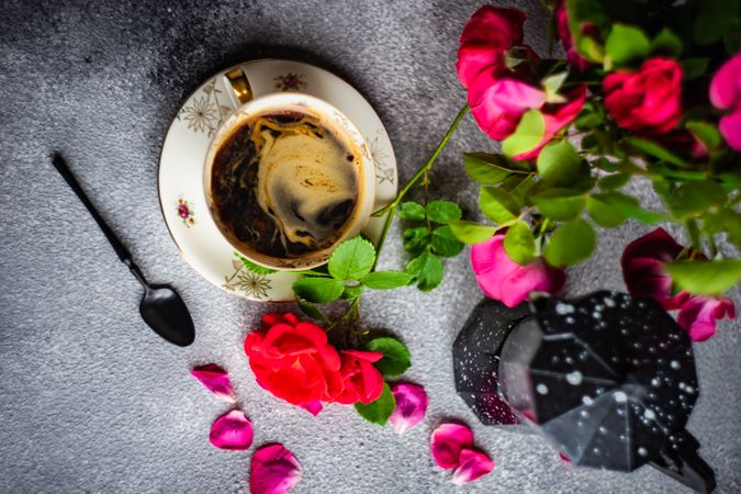 Coffee set with red roses and moka pot on concrete background with copy space