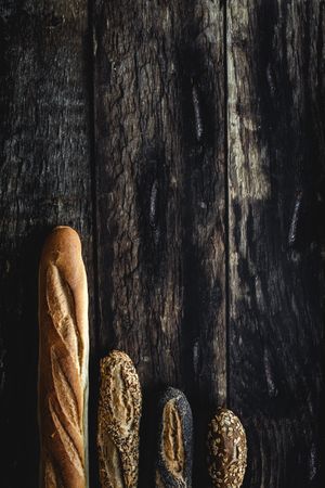 Assorted gold homemade bread on dark wood background