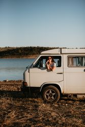 Smiling woman sitting in retro car