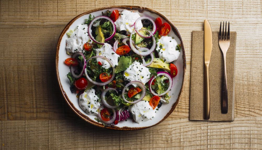 Vegetables salad with onion greens and cream sauce