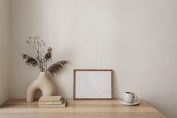 Vase, poster mock up and cup of coffee on wooden table