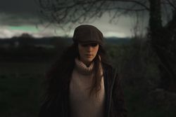 Young woman in warm clothes in forest