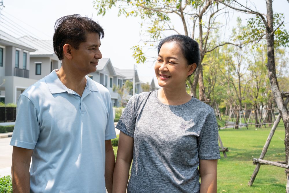 Male and female standing on walkway in residential area